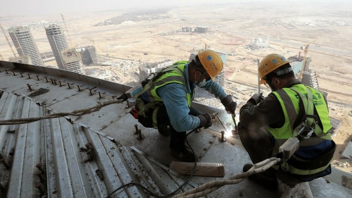Robotníci na stavbe výškovej budovy v novej Káhire.