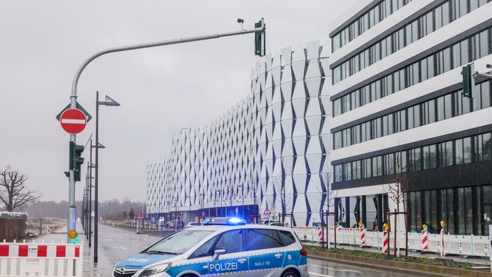 Policajné auto parkuje neďaleko parkovacieho domu na letisku v nemeckom meste Frankfurt nad Mohanom.