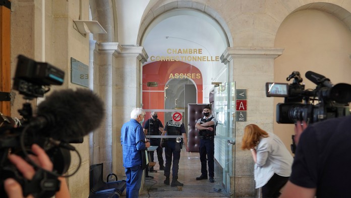 Reportéri čakajú pred vchodom do súdnej siene.