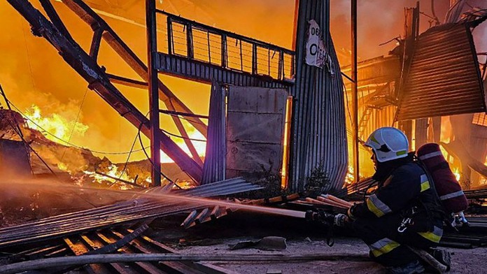 Hasiči pracujú na uhasení požiaru po ruskom útoku v Ľvove.