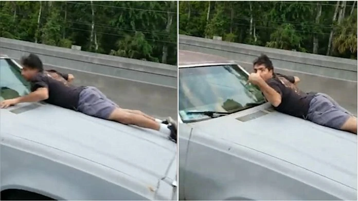 Muž na kapote svojho auto, ktoré mu chceli ukradnúť