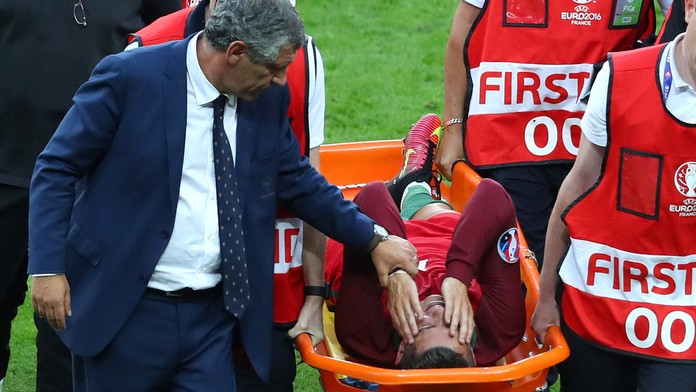 Tréner Portugalska Fernando Santos upokojuje svojho zraneného hráča Cristiana Ronalda.