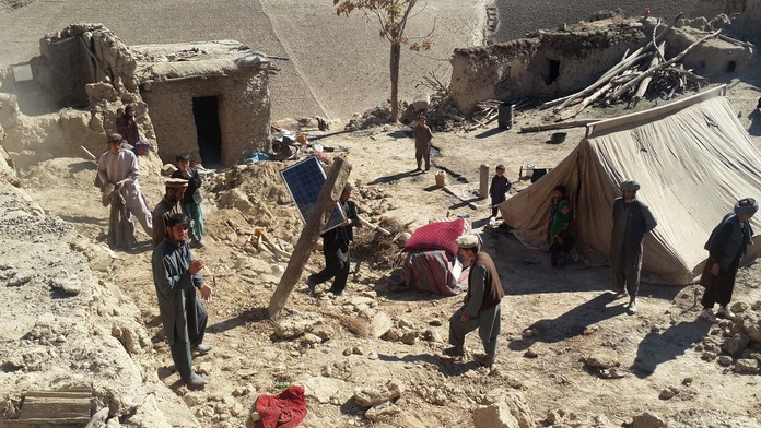 Afganski muži zbierajú veci  po zemetrasení v provincii Tachár, severovýchodne od Kábulu. 27. októbra