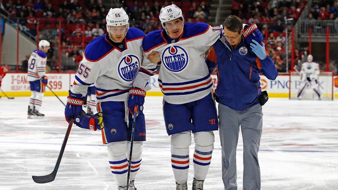 Ruský útočník Naiľ Jakupov s lekárom a spoluhráčom Markom Letestuaom odchádza z ľadu po kolízii s čiarovým rozhodcom.