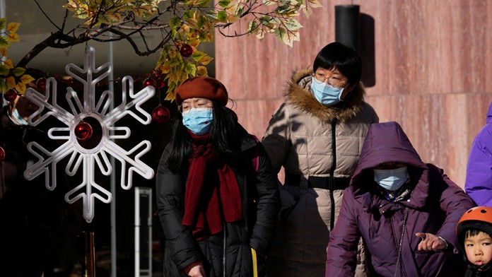 Obyvatelia Pekingu s ochrannými rúškami na tvári.