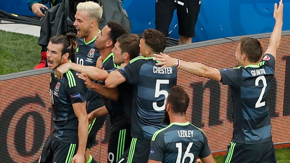 Walesan Gareth Bale (v popredí) sa teší so spoluhráčmi po strelení gólu z priameho kopu proti Anglicku..