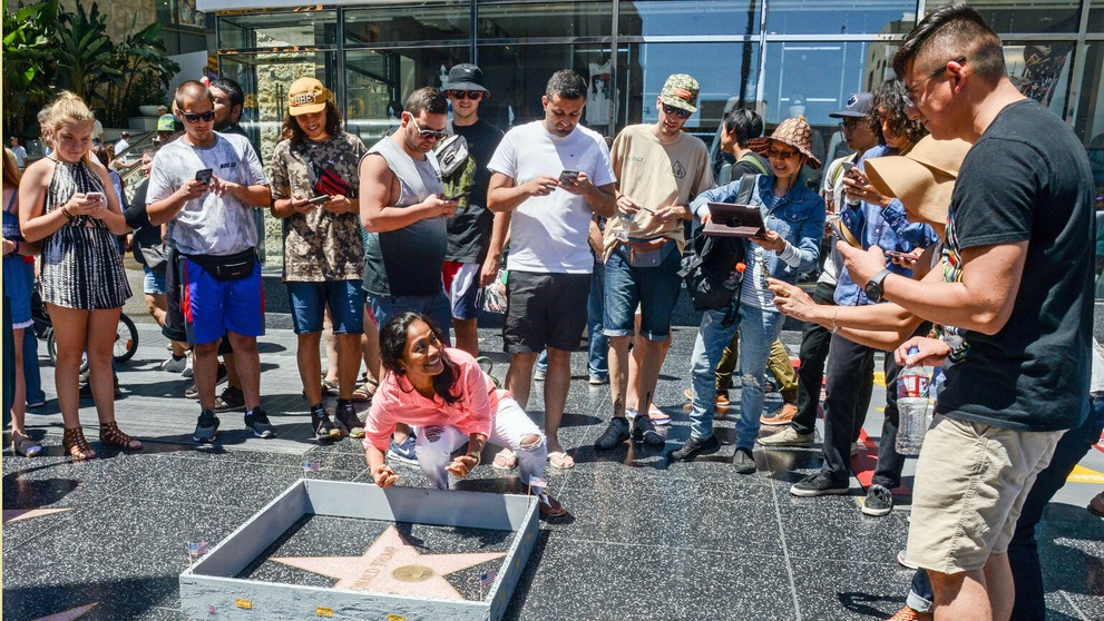 Turistka sa fotí pri Trumpovom múre.