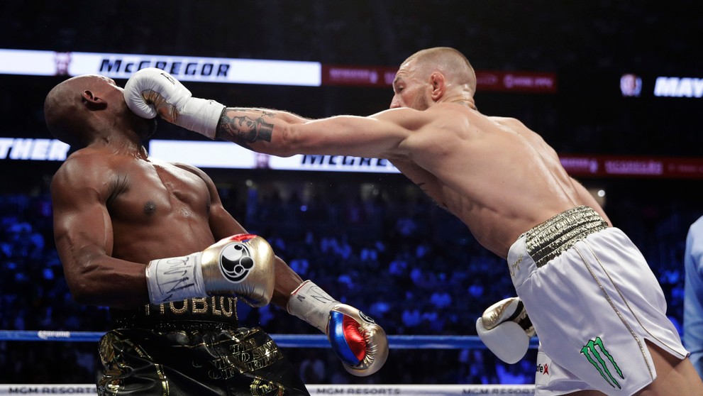 Tvrdá rana Conora McGregora (vpravo) v dueli proti Floydovi Mayweatherovi.