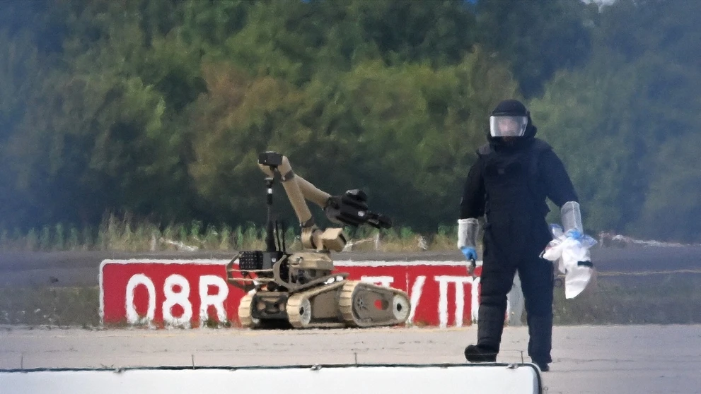 Forenzný technik pracuje spolu s robotom na zneškodňovanie bômb v blízkosti ukrajinského lietadla na letisku Lipsko/Halle.