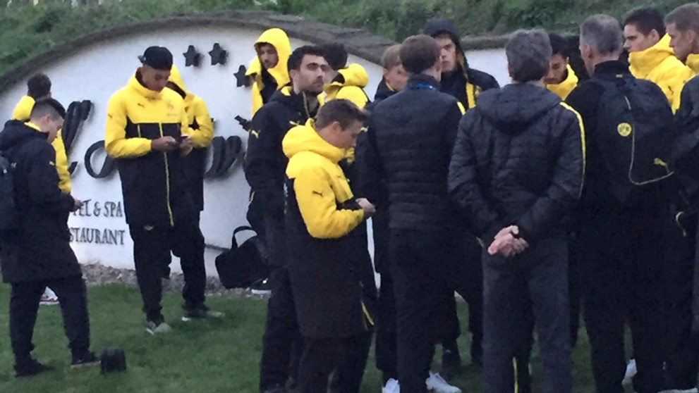 Hráči Borusisie Dortmund stoja po evakuovaní po výbuchu bomby, v strede tréner Thomas Tuchel.