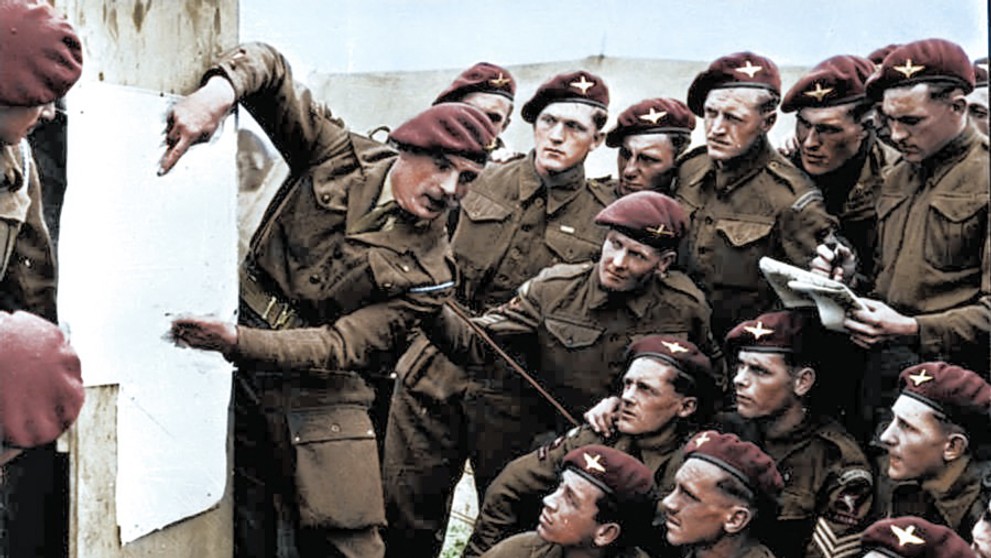 Britskí parašutisti dostávajú pokyny pred zoskokom na Normandiou