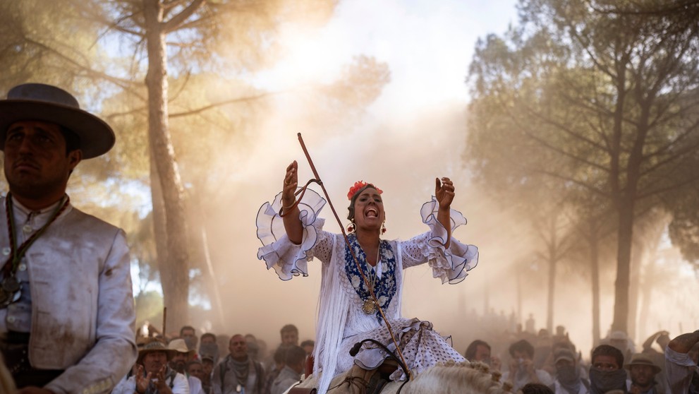 Žena sedí v sedle koňa v Národnom parku Donana počas púte k svätyni Panny Márie El Rocío v dedine El Rocío na juhu Španielska.