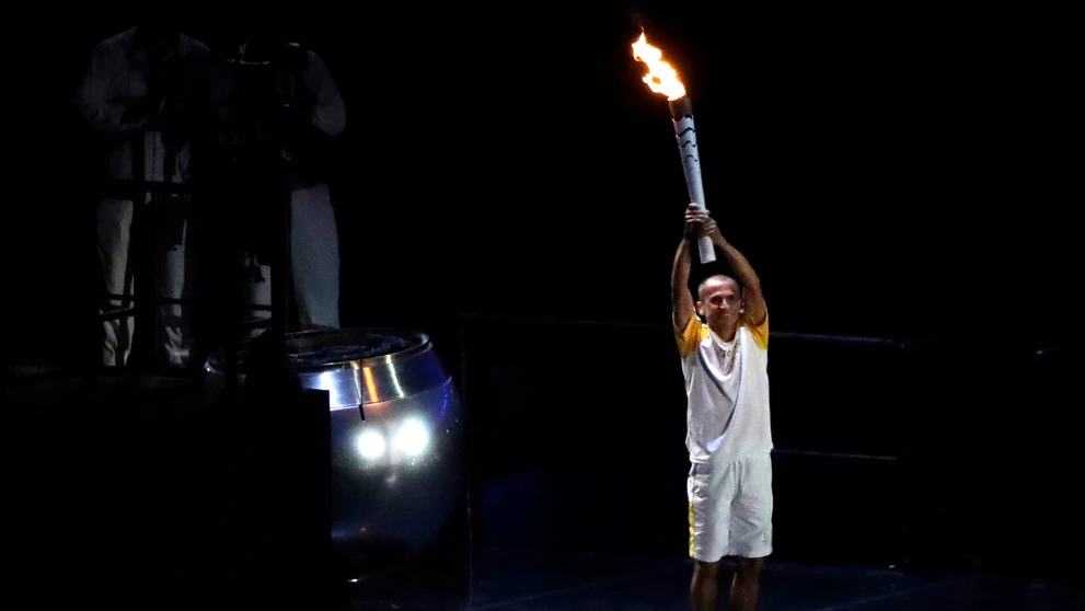 Bývalý maratónec Vanderlei Cordeiro de Lima zapaľuje olympijský oheň.