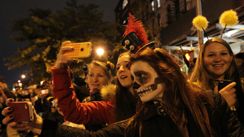 Zamaskovaní ľudia si robia selfie počas halloweenskeho sprievodu v New Yorku.
