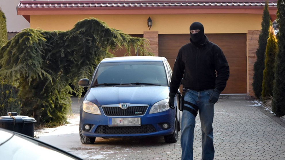 Príslušník NAKA pred domom, ktorý má údajne vlastniť firma brata Antonina Vadalu - Sebastiana.