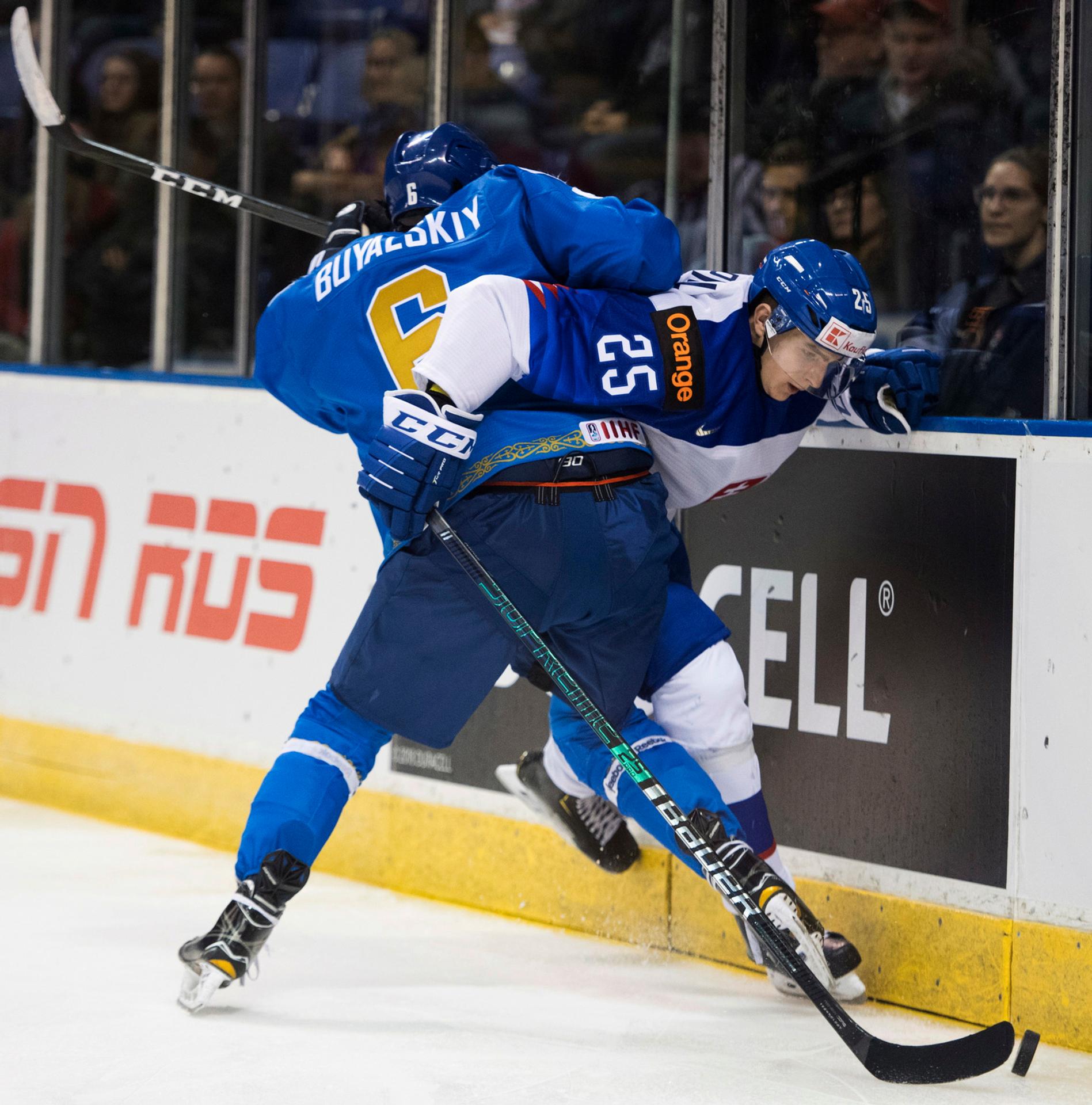 Martin Fehérváry padá cez gólmana Samuela Hlavaja počas toho, ako sa Kazach Baatyrlan Muratov snaží dať gól v dueli na MS do 20 