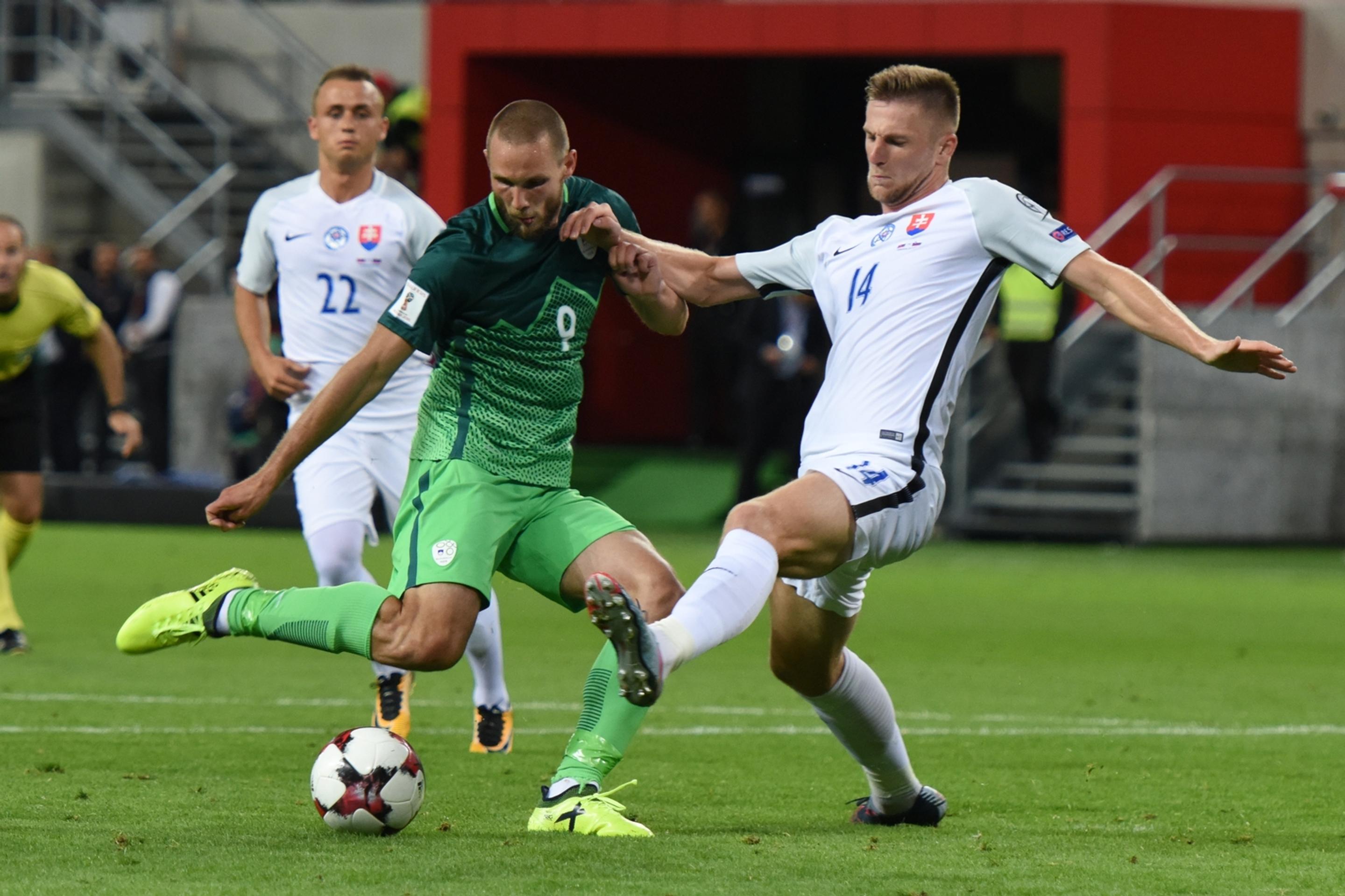 Na snímke vpravo hráč Slovenska Milan Škriniar a hráč Slovinska Tim Matavž v zápase kvalifikácie MS.