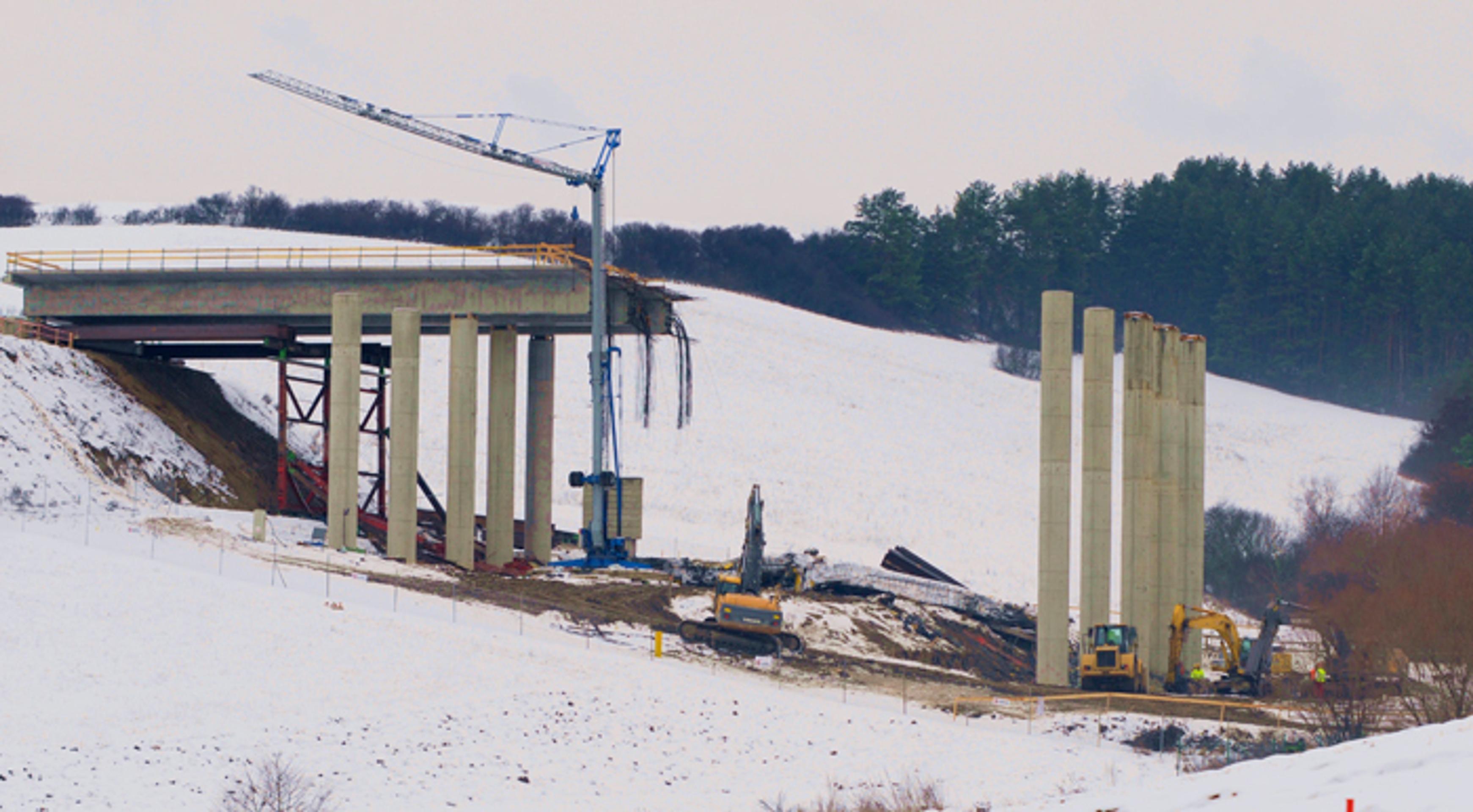 Ťažké mechanizmy odstraňujú trosky spadnutého mosta pri Kurimanoch (20. decembra 2012). 