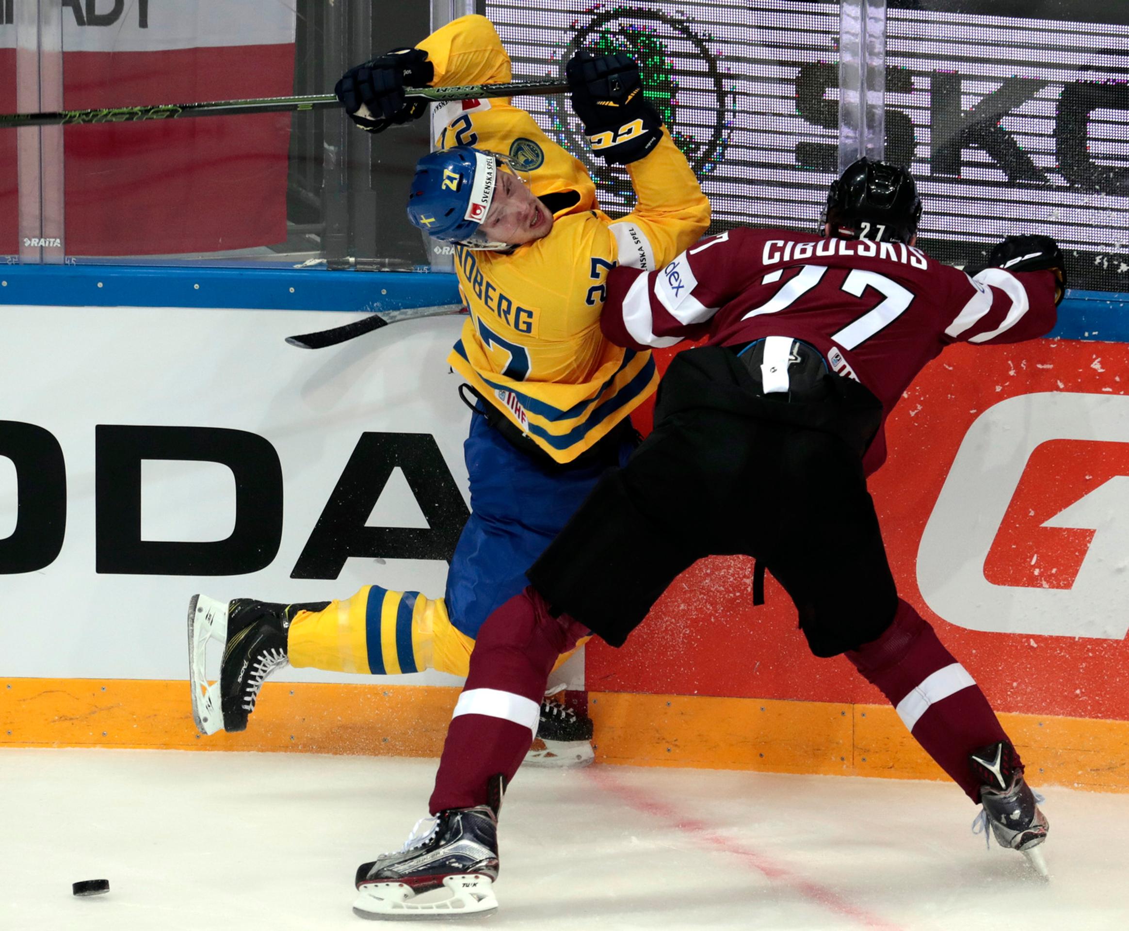 V dôraznom súboji Švéd Martin Lundberg (vľavo) proti Lotyšovi Oskarsovi Cibulskisovi počas vzájomného duelu na MS v Rusku.
