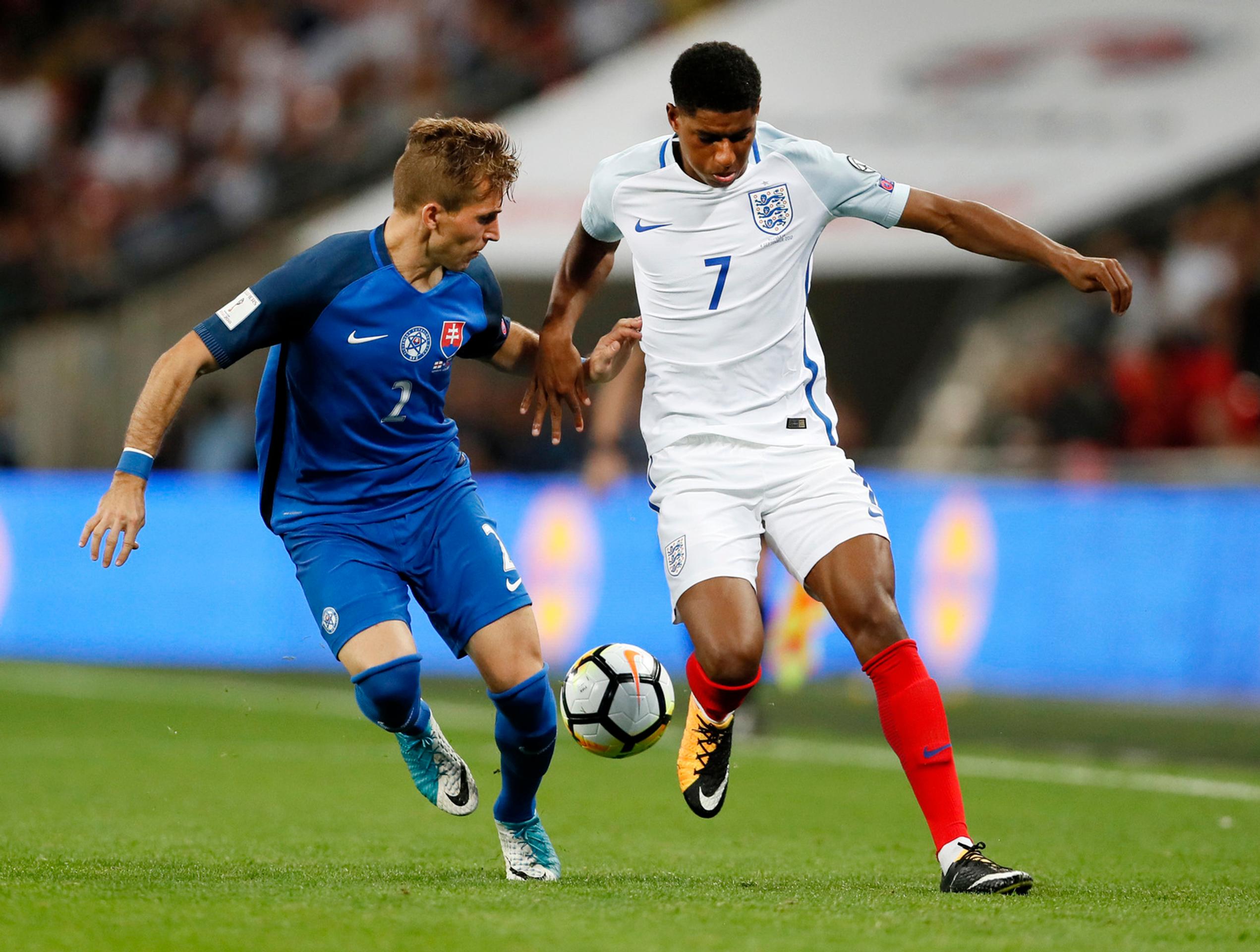 Angličan Marcus Rashford (vpravo) uniká s loptou v zápase kvalifikácie MS, prizerá sa Peter Pekarík.