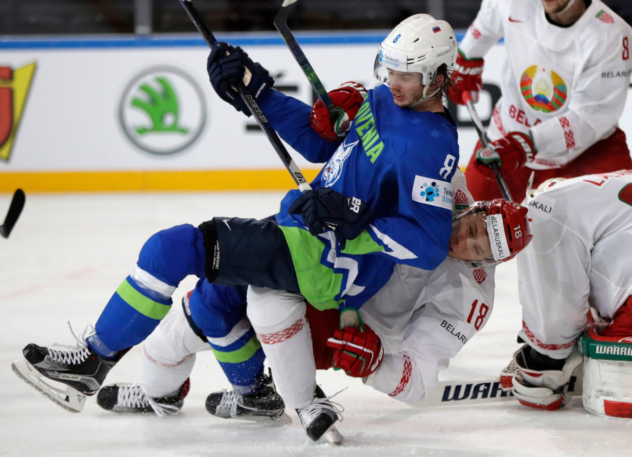 Kristian Chenkel (vpravo) z Bieloruska posiela na ľad v dueli MS 2017 Slovinca Žigu Jegliča.
