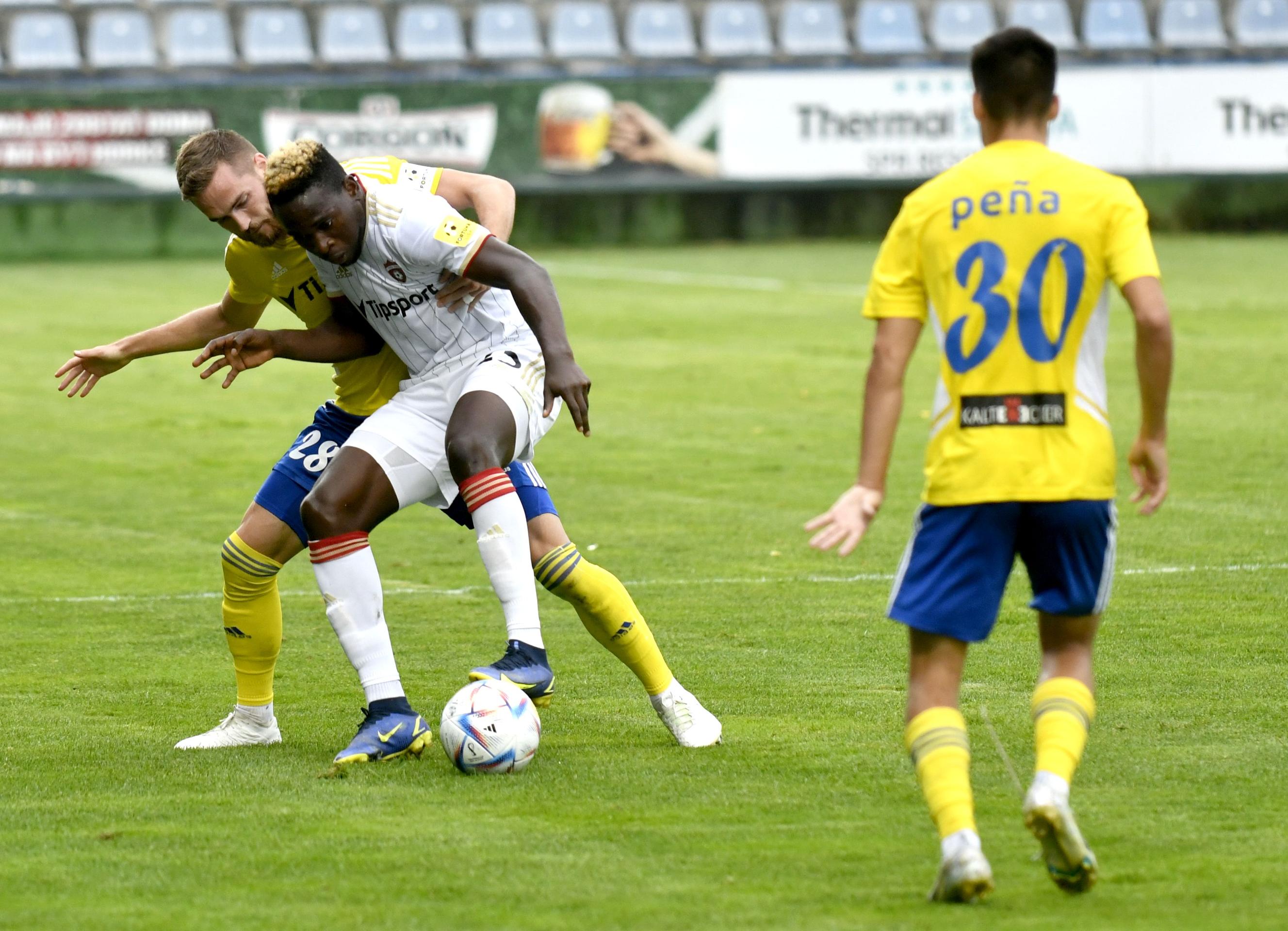Zľava hráč MFK Zemplín Michalovce Juraj Kotula a jeho spoluhráč Brain Peňa, uprostred hráč FC Spartak Trnava Yusuf Bamidele v 5. kole Fortuna ligy.
