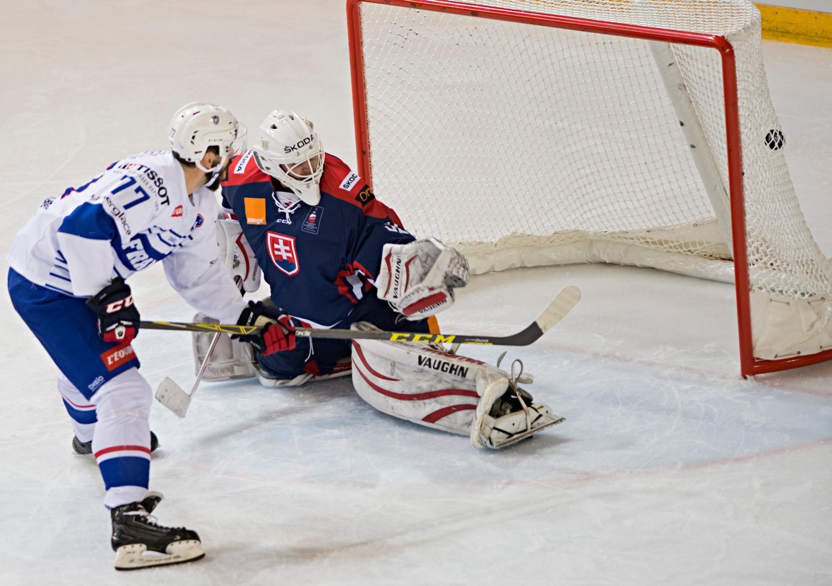 Na snímke francúzsky hokejista Sacha Treille prekonáva slovenského brankára Branislava Konráda