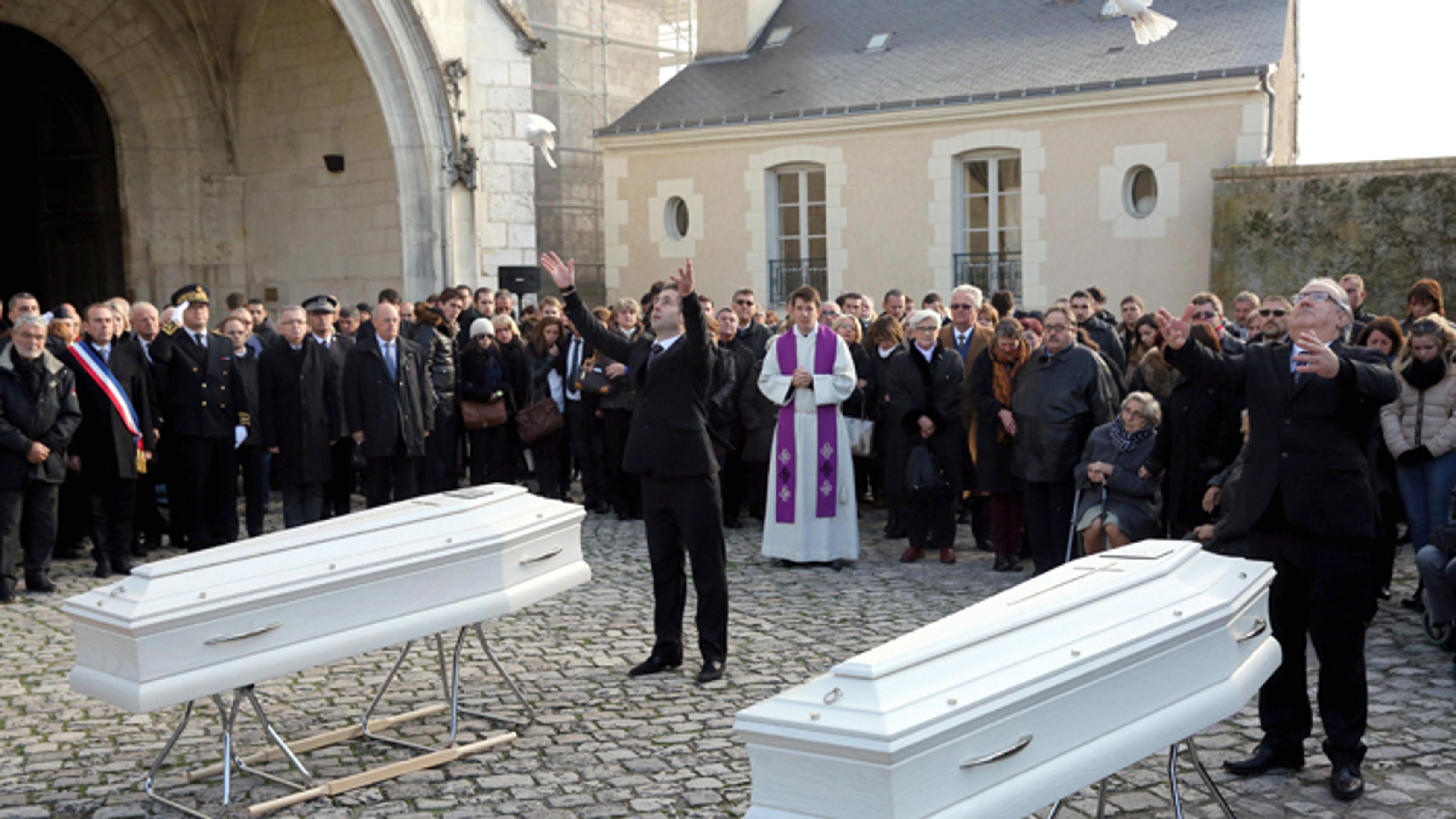 Nosiči vypúšťajú holubice počas pohrebu dvoch sestrier Marion a Anny Petardových vo francúzskom meste Blois.
