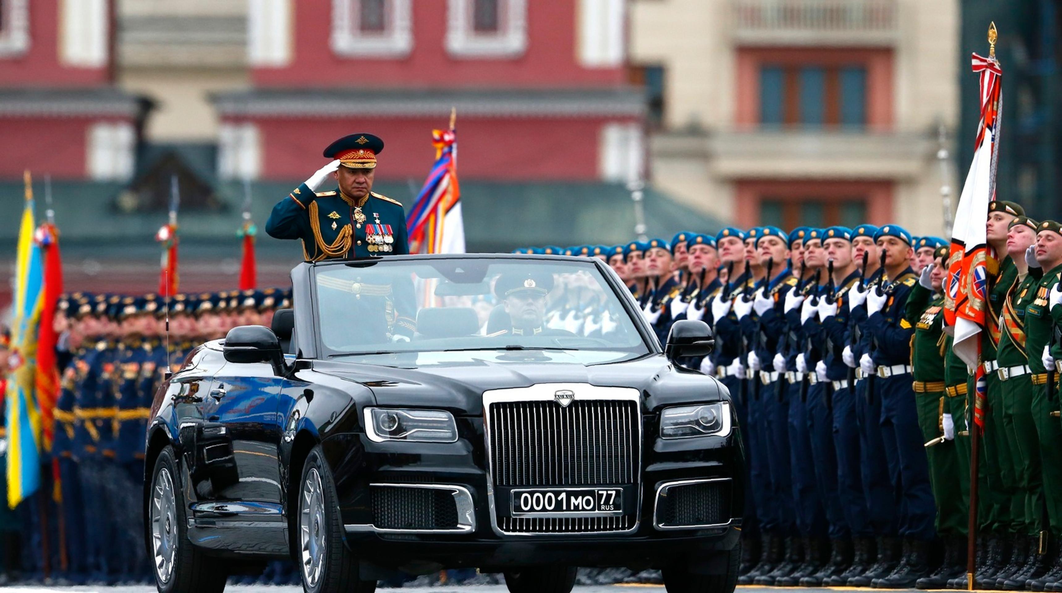Ruský minister obrany Sergej Šojgu zdraví vojakov z limuzíny Aurus Senat počas vojenskej prehliadky na Červenom námestí v Moskve