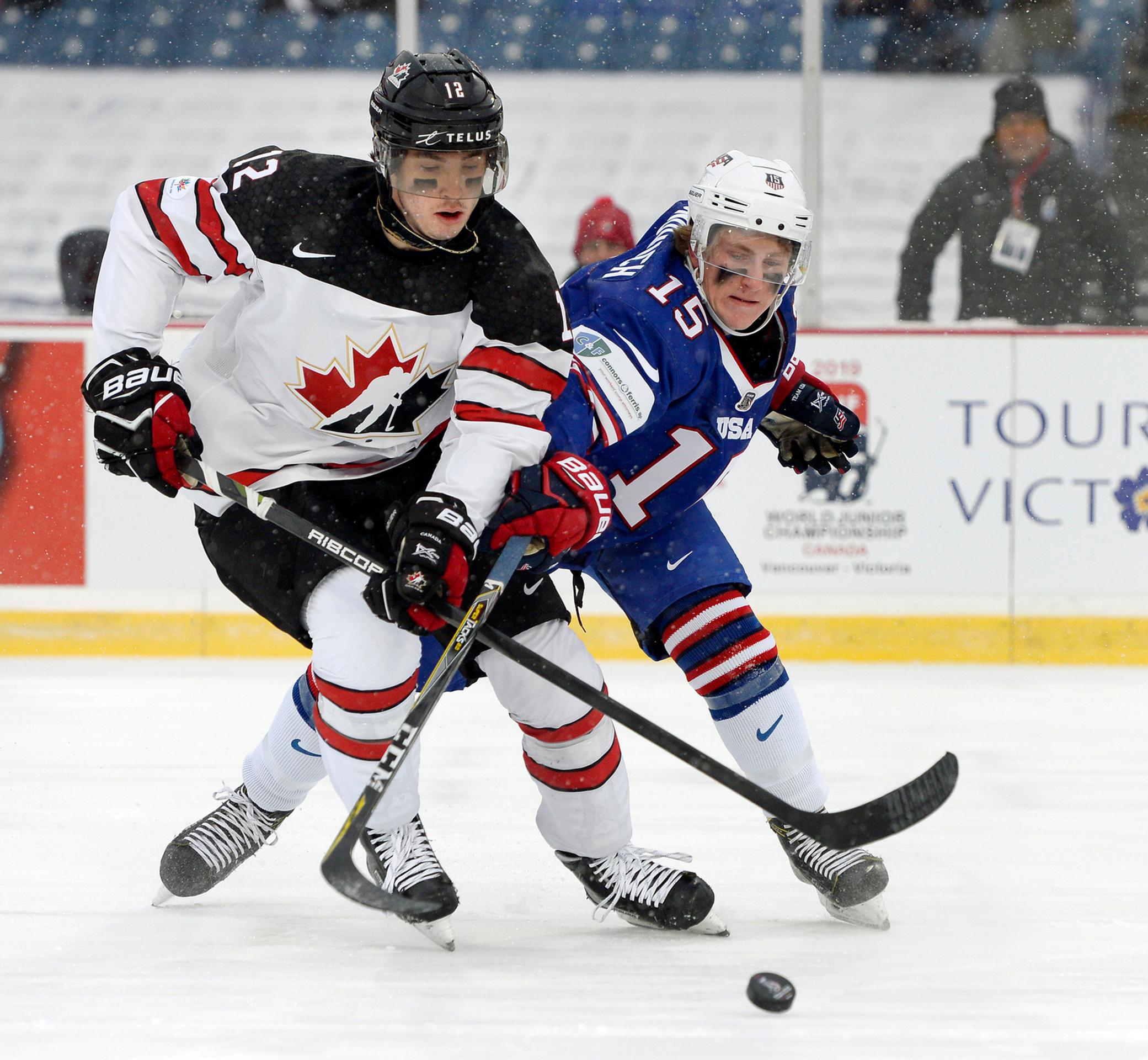 Bek Kanady Cale Makar (vľavo) atakuje Adama Foxa z USA v dueli MS 20.