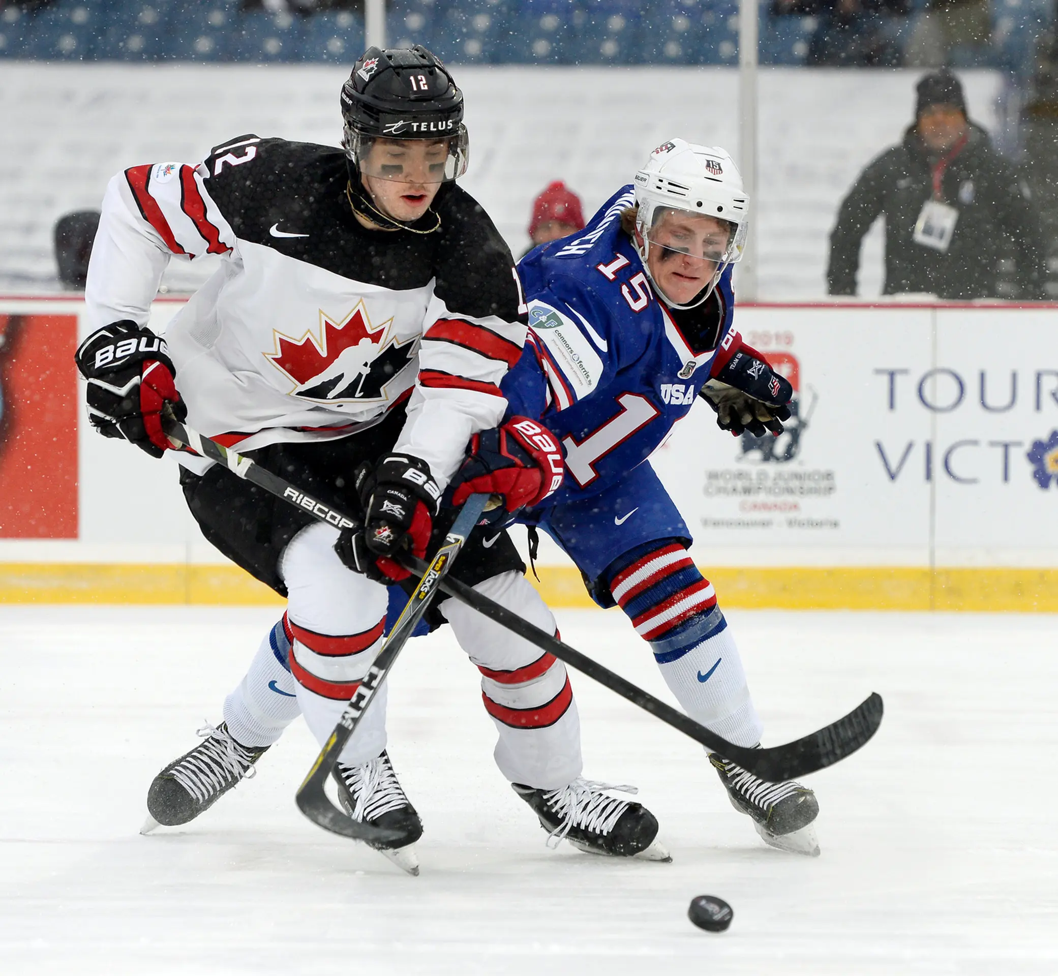 Bek Kanady Cale Makar (vľavo) atakuje Adama Foxa z USA v dueli MS 20.