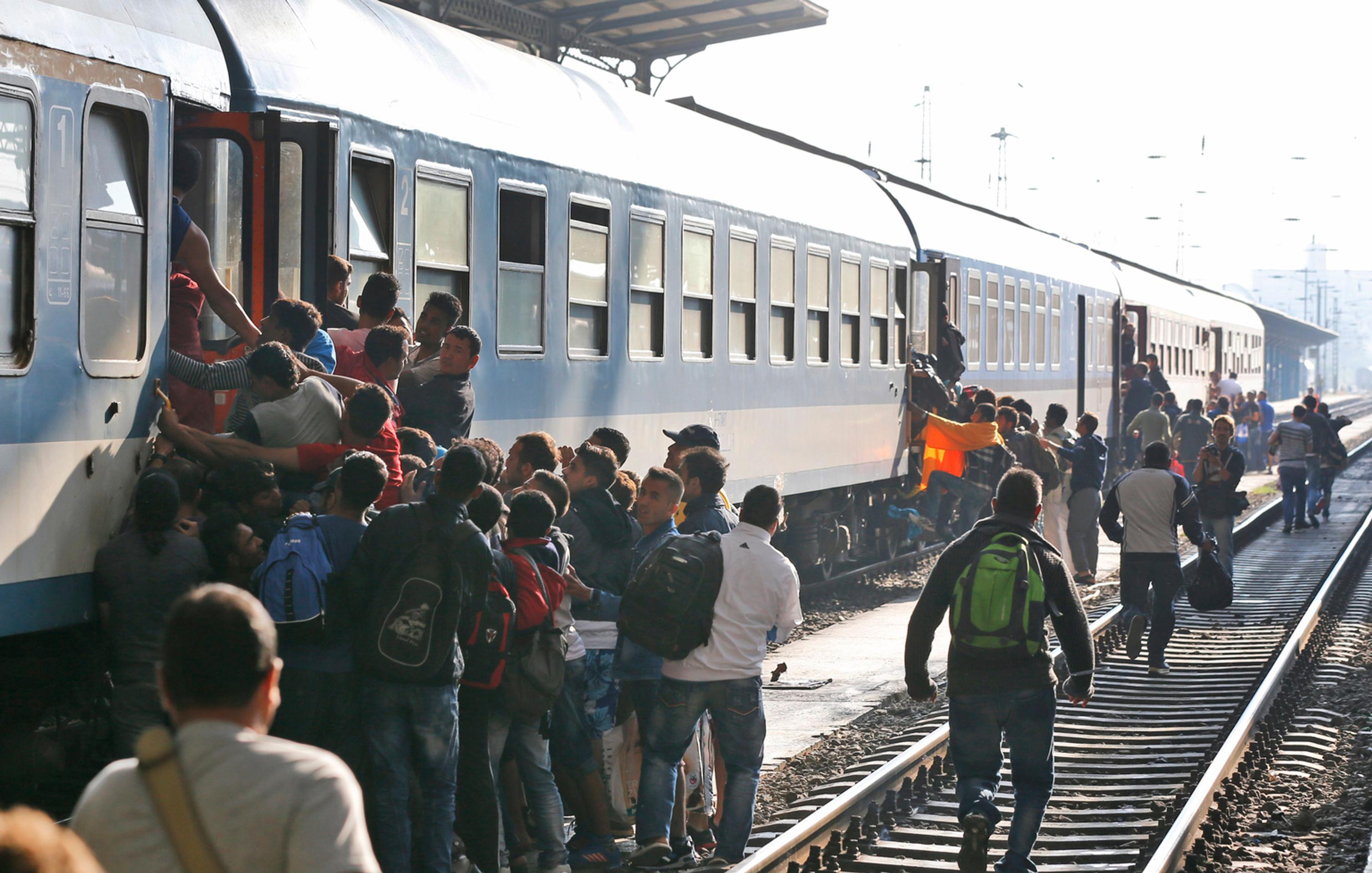 Migranti sa snažia nastúpiť do vlaku v Budapešti.
