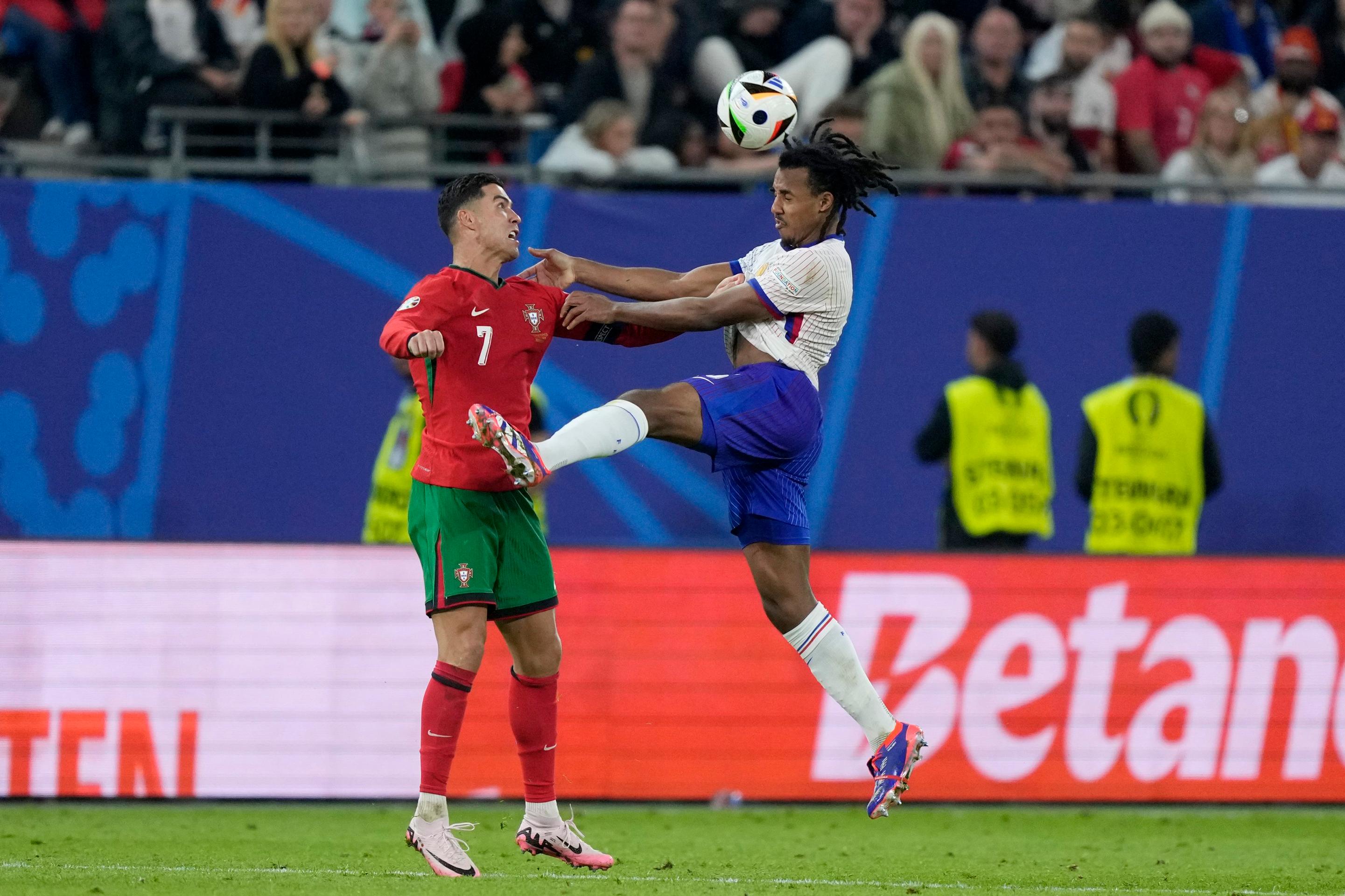 Cristiano Ronaldo a Jules Kounde v súboji.